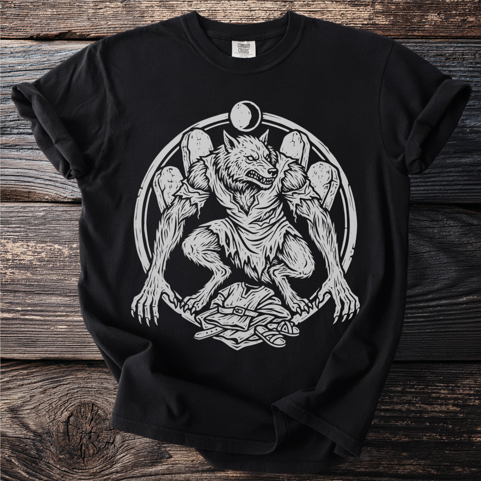 Werewolf transformation design on black t-shirt with moon and gravestones.