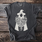 Dark gray t-shirt with white graphic of a witch holding a bouquet, stars, and moons.