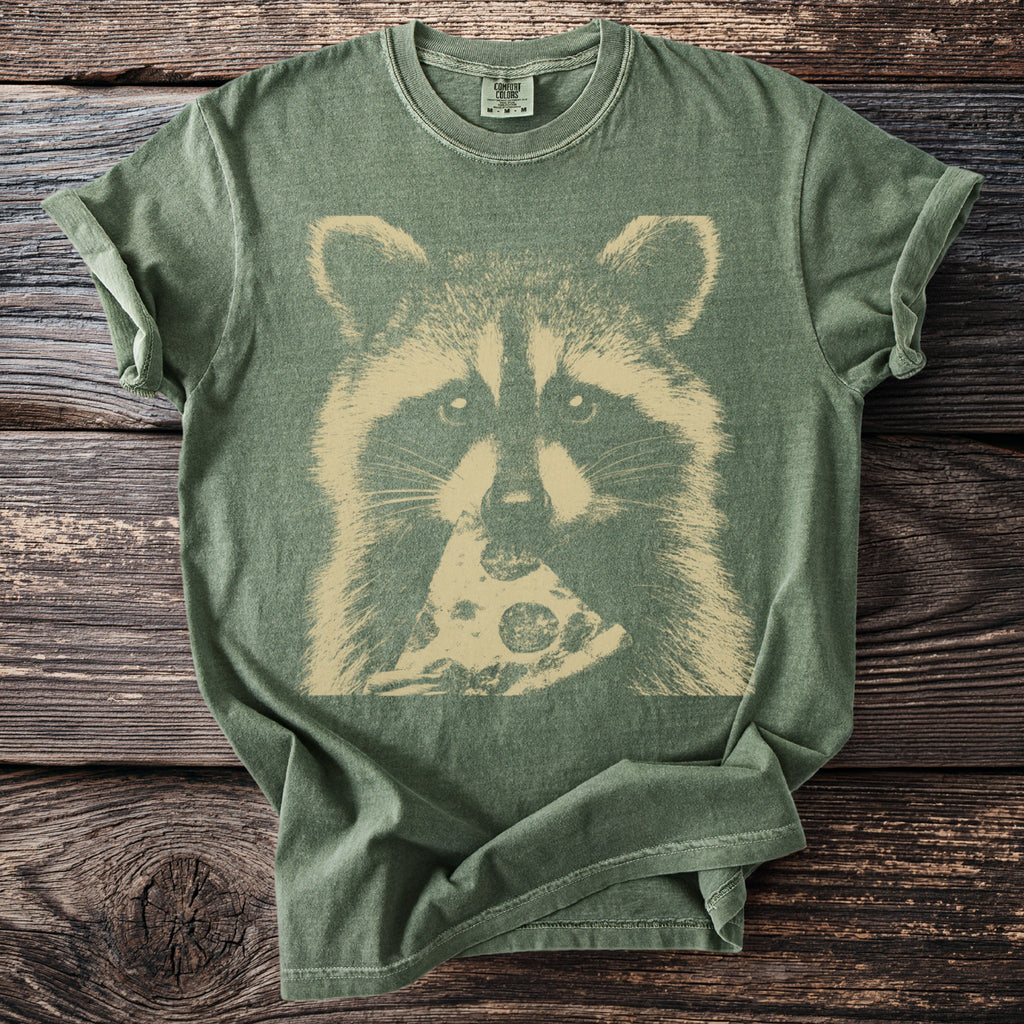 Green t-shirt with a beige graphic of a raccoon eating a slice of pizza.