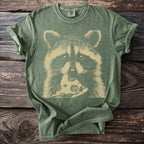 Green t-shirt with a beige graphic of a raccoon eating a slice of pizza.
