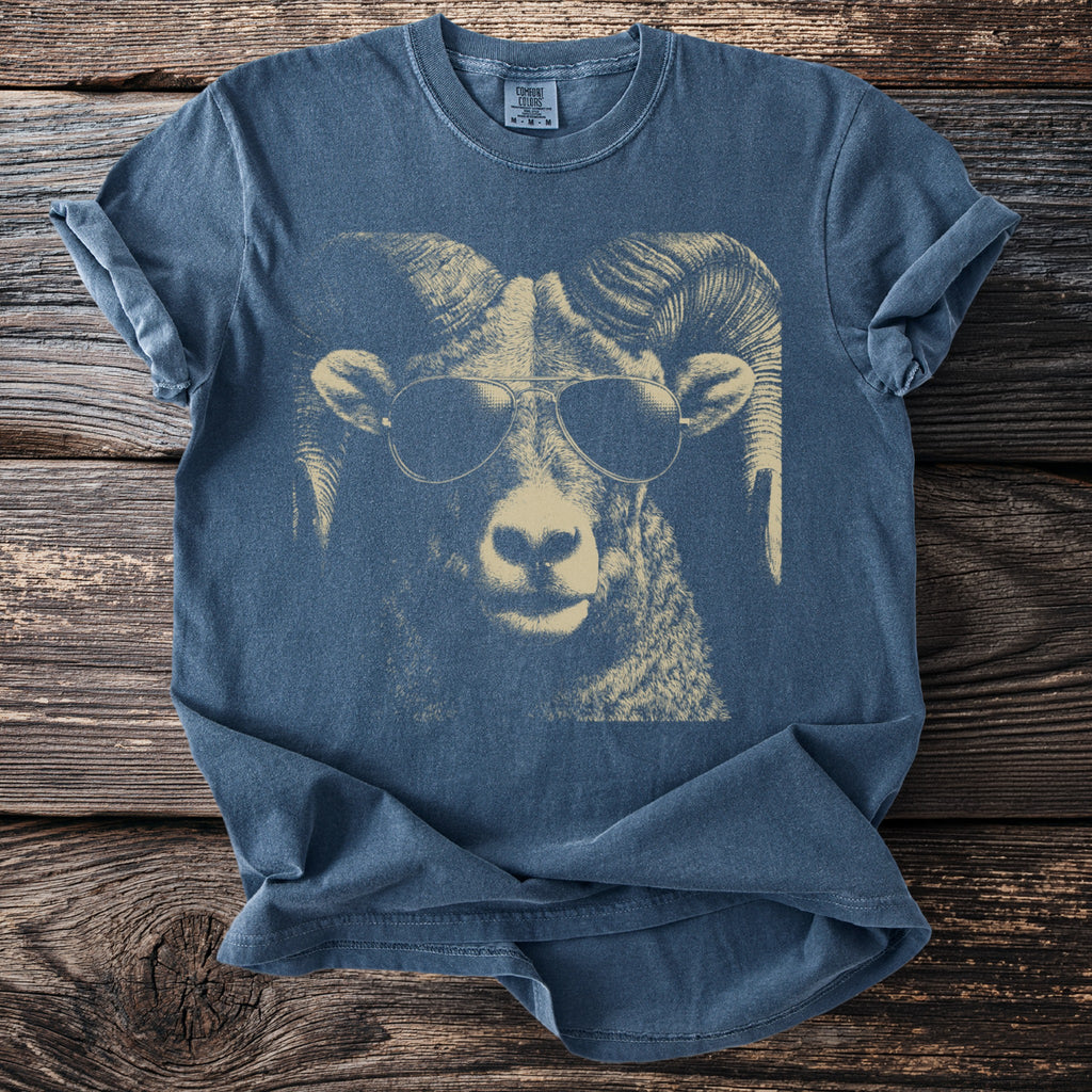 Blue t-shirt with a cream-colored graphic of a ram wearing sunglasses.