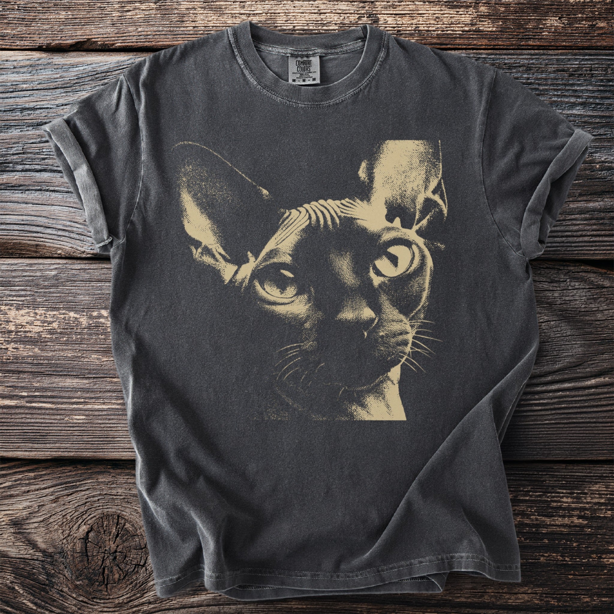 Dark gray t-shirt featuring a beige Sphinx cat graphic with large eyes.