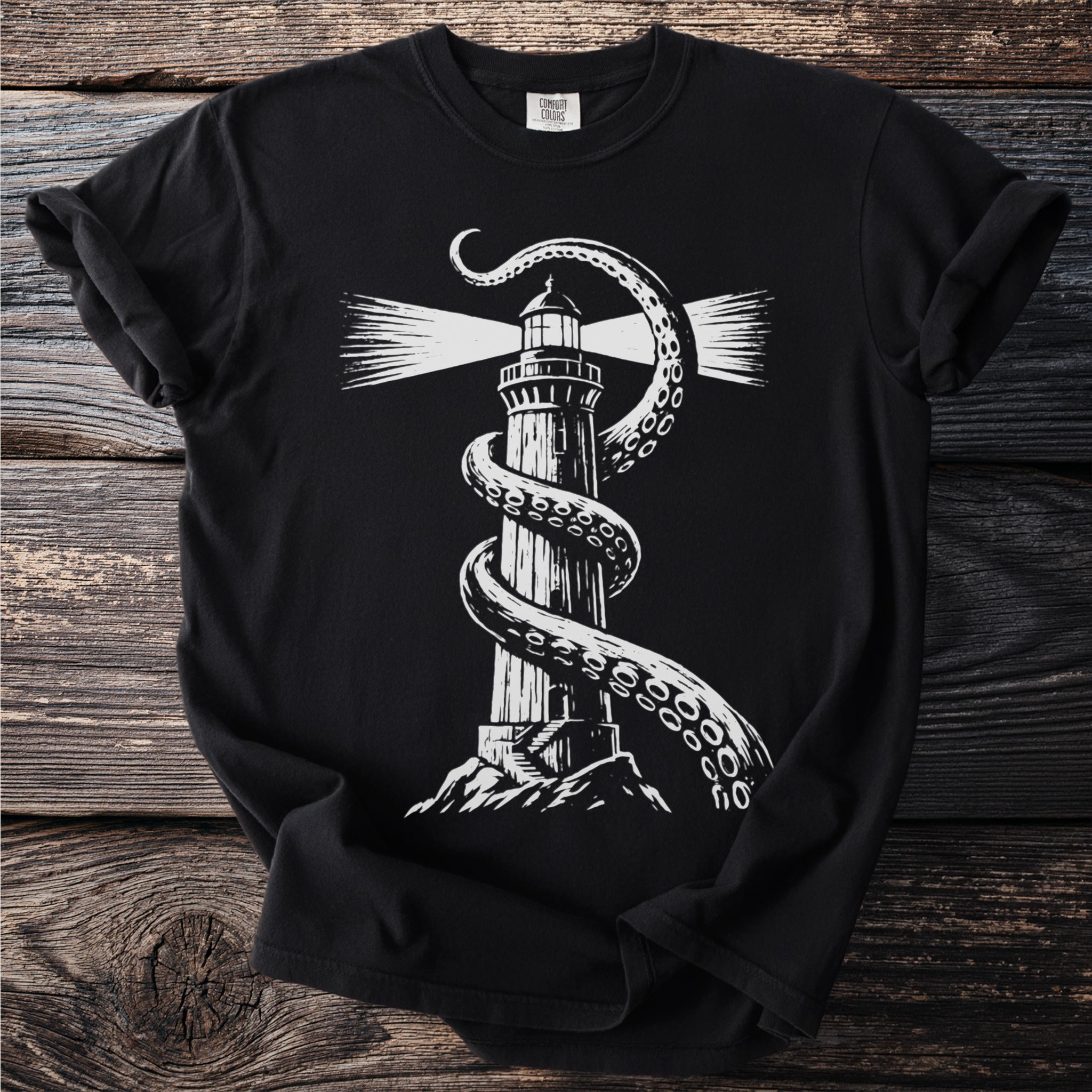 Black t-shirt with white lighthouse design wrapped by octopus tentacles.