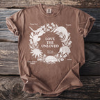 Brown t-shirt with white graphic of "LOVE THE UNLOVED" and surrounding animals.