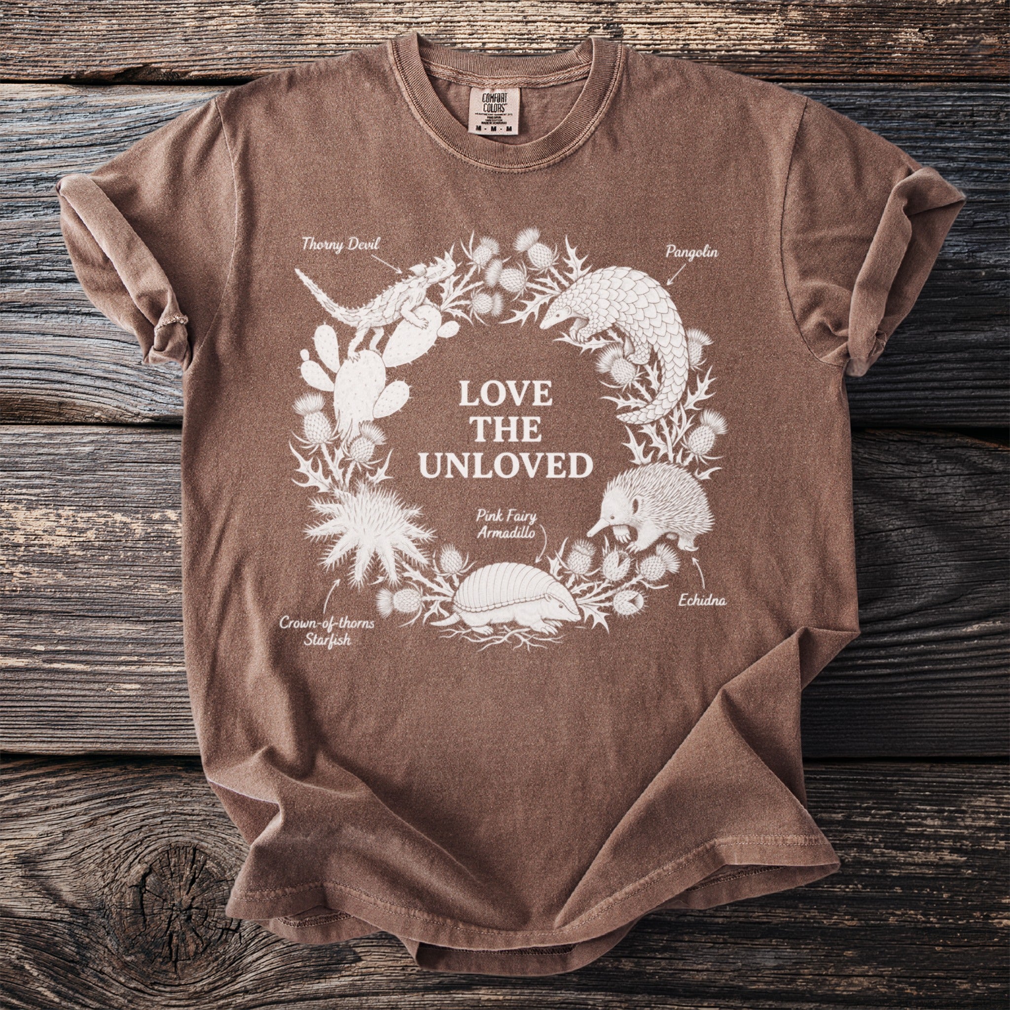 Brown t-shirt with white graphic of "LOVE THE UNLOVED" and surrounding animals.
