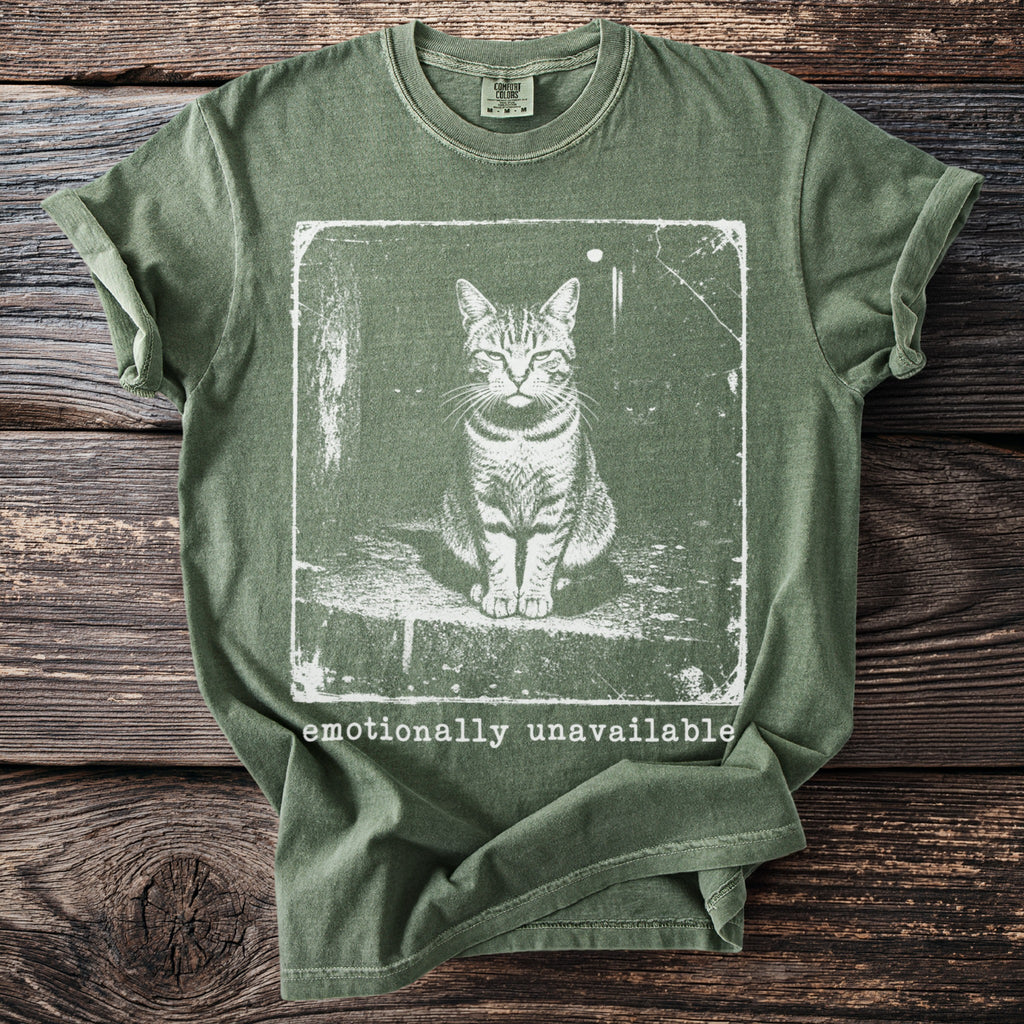 Olive green t-shirt with a distressed print of a cat and the text "emotionally unavailable."