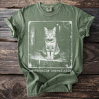 Olive green t-shirt with a distressed print of a cat and the text "emotionally unavailable."