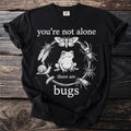 Black t-shirt with "you're not alone there are bugs" and a circular insect design.