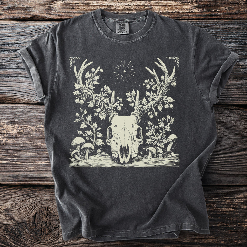 Dark grey t-shirt with a cream linocut design of a deer skull with antlers and surrounding foliage.