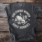 Dark grey t-shirt with "God forbid women have hobbies" and occult imagery.