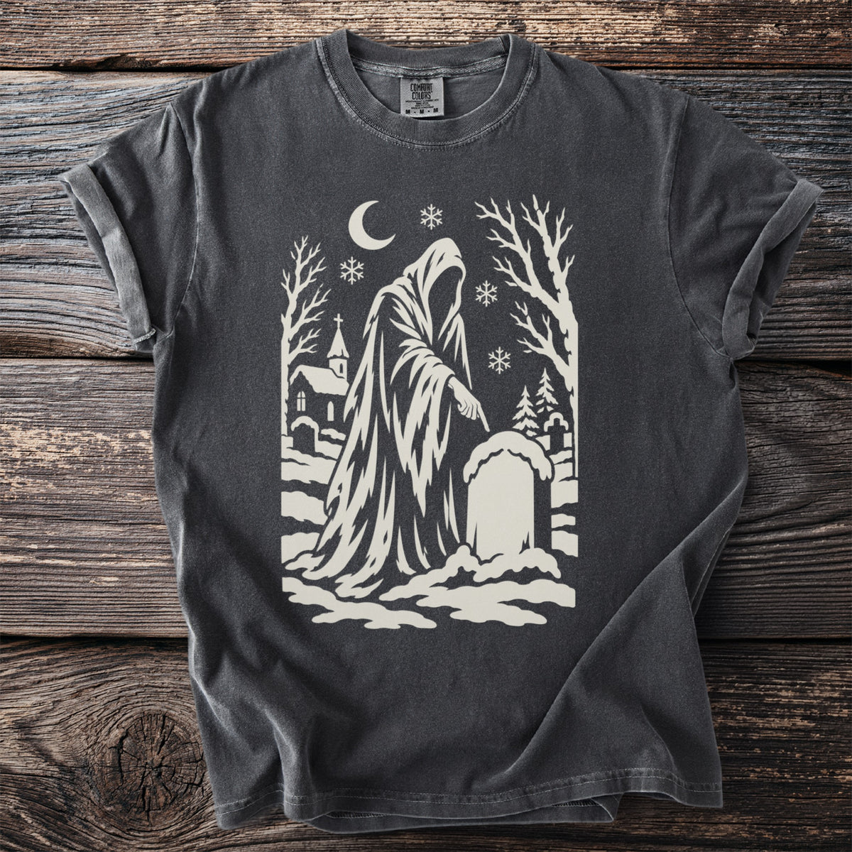 Pepper gray t-shirt with a cream folk-cut print: the hooded Ghost of Christmas Yet to Come points one finger at a snowy grave.