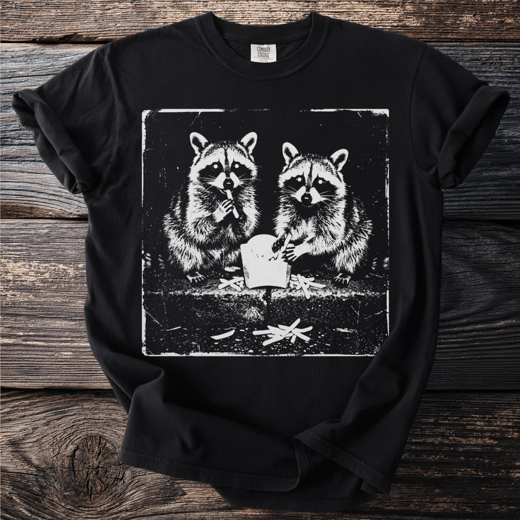 Black t-shirt featuring distressed graphic of two raccoons eating french fries.