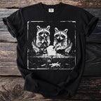 Black t-shirt featuring distressed graphic of two raccoons eating french fries.
