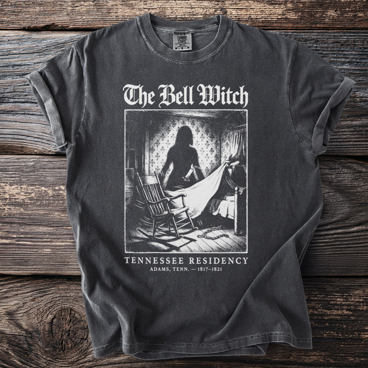 The Bell Witch shirt with a shadowy figure, rocking chair, and text about Tennessee Residency.