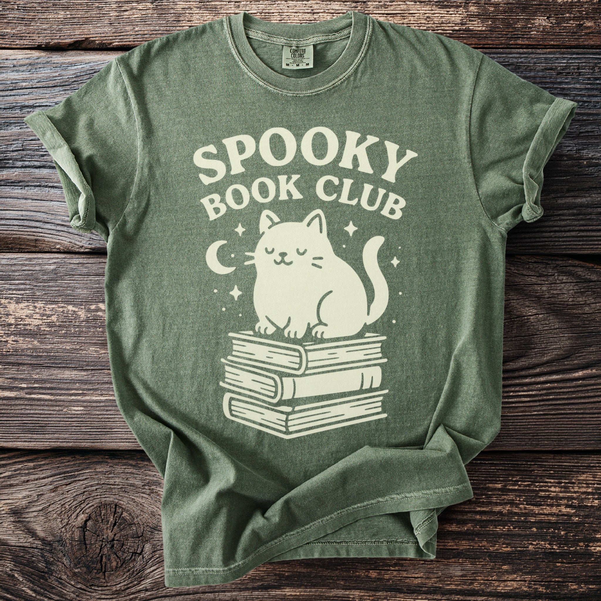 Green t-shirt with "SPOOKY BOOK CLUB" text and a cat on books.