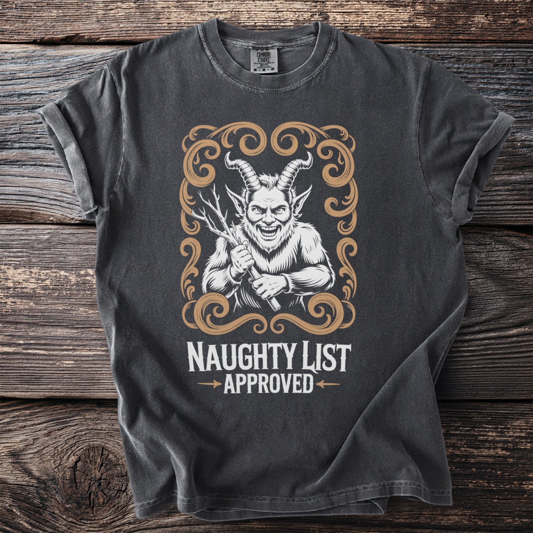 Dark t-shirt with a graphic of a horned, furry creature holding branches, saying "Naughty List Approved."