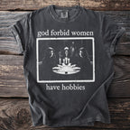 T-shirt with "god forbid women have hobbies" text and spooky graphic.