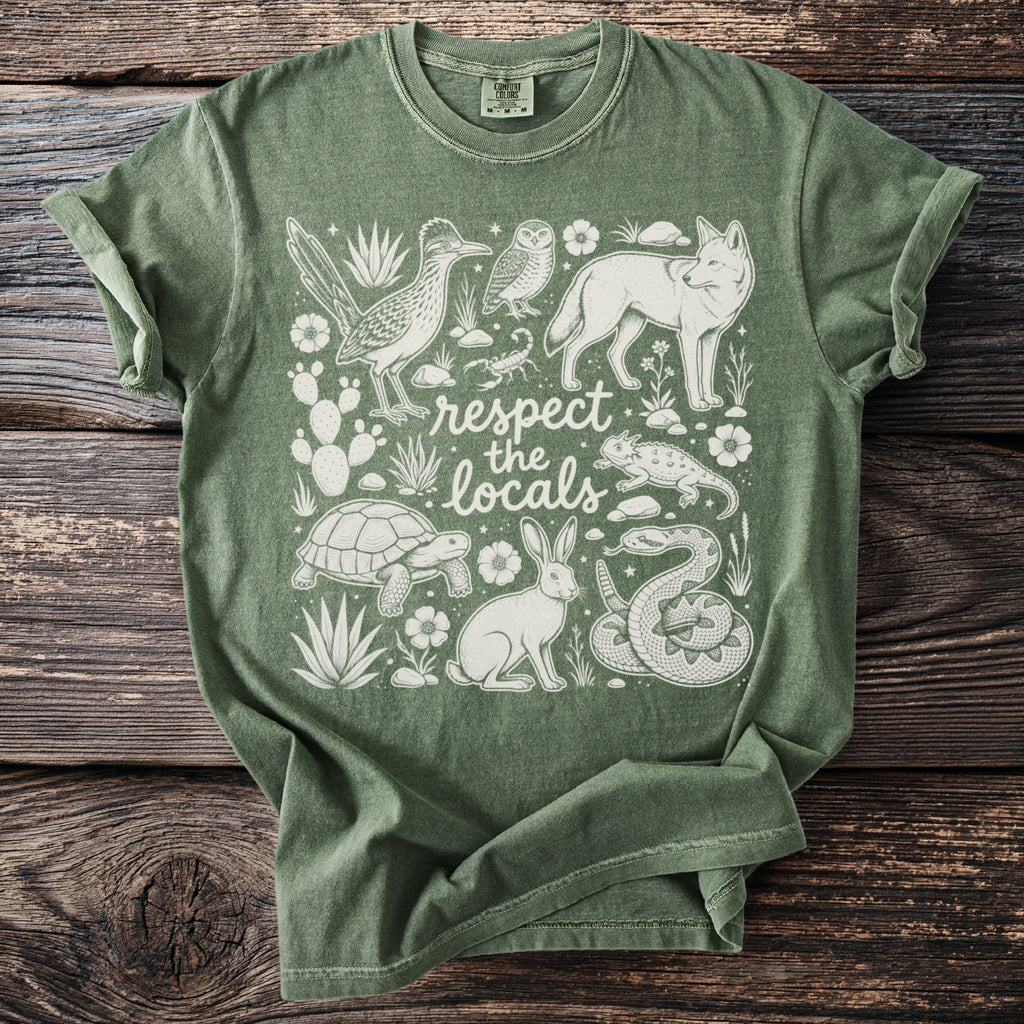 Green t-shirt with white desert animals and plants, and "respect the locals" text.