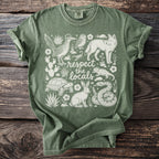 Green t-shirt with white desert animals and plants, and "respect the locals" text.