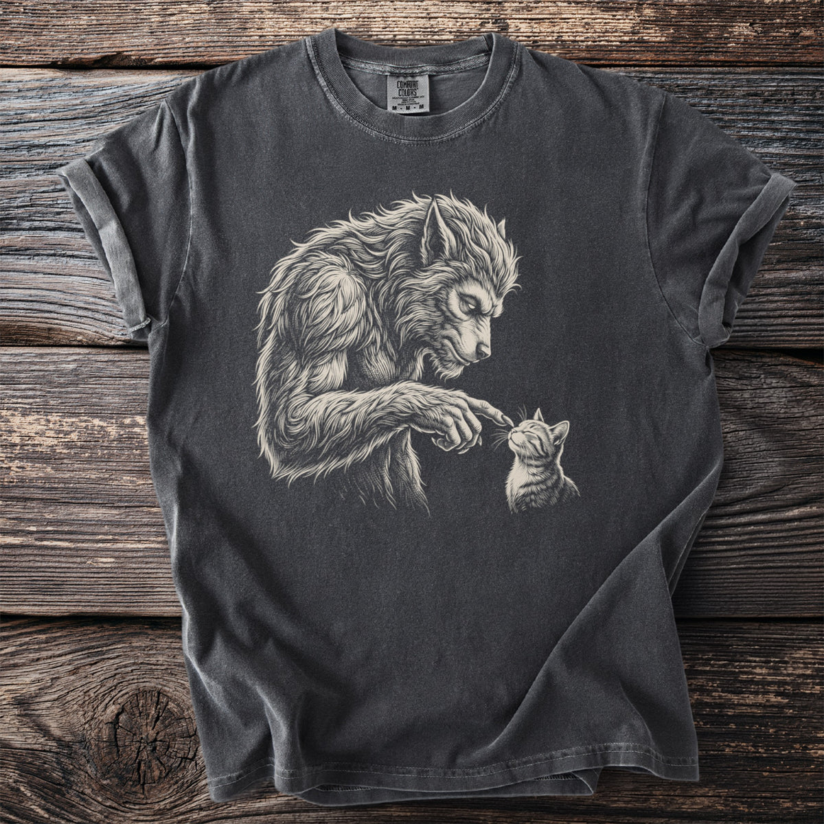 Werewolf gently touching a kitten on a charcoal gray t-shirt.