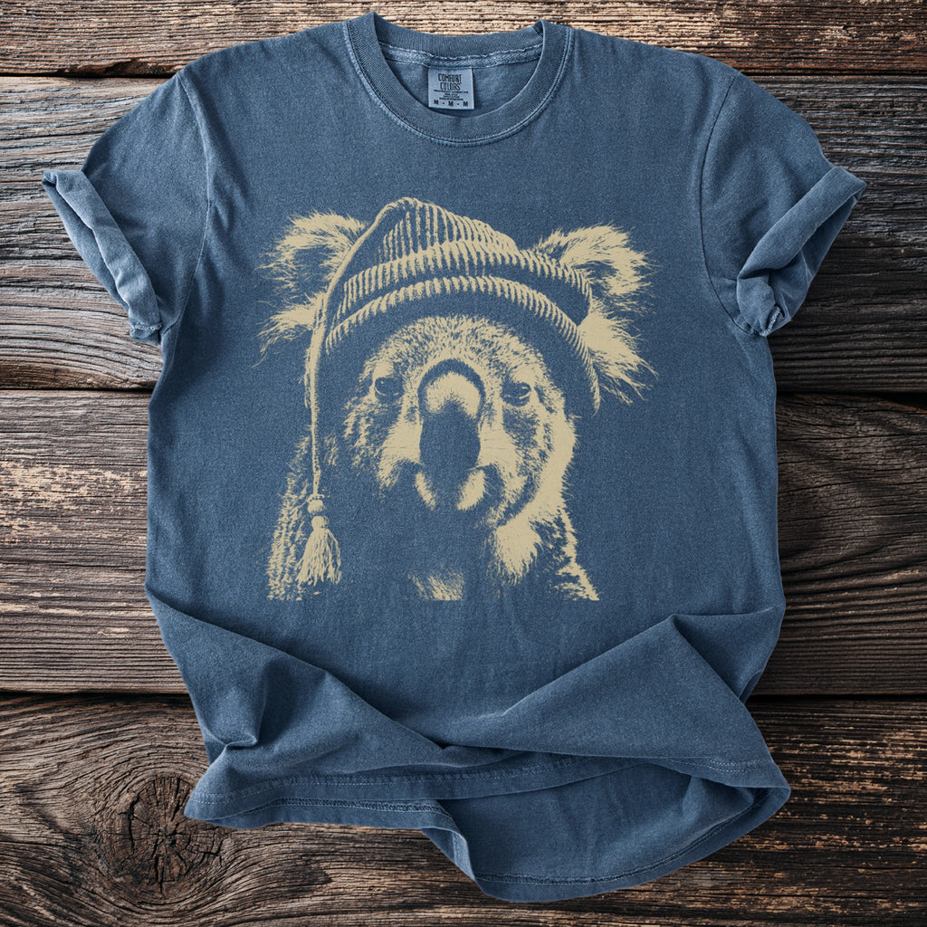 Blue t-shirt with a distressed print of a koala wearing a beanie. Comfort Colors label visible.