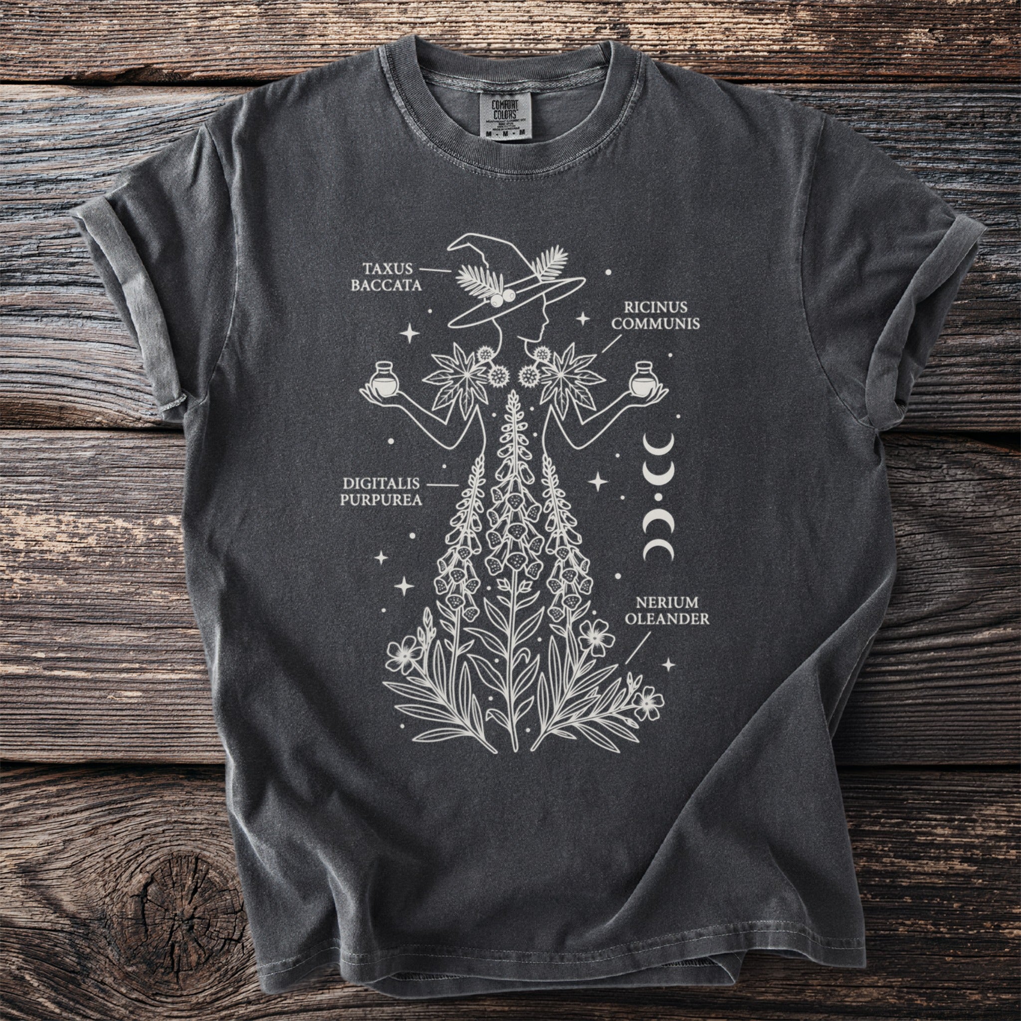 Gray t-shirt with white botanical illustration of a witch with plants and moon phases.