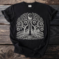 Black t-shirt with a white graphic of a moon, tree, well, house, and celestial fruit.
