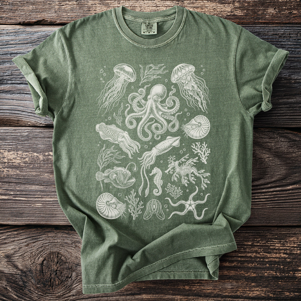 Green t-shirt with printed white line art of marine life including octopus, jellyfish, and seahorse.