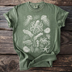 Green t-shirt with printed white line art of marine life including octopus, jellyfish, and seahorse.