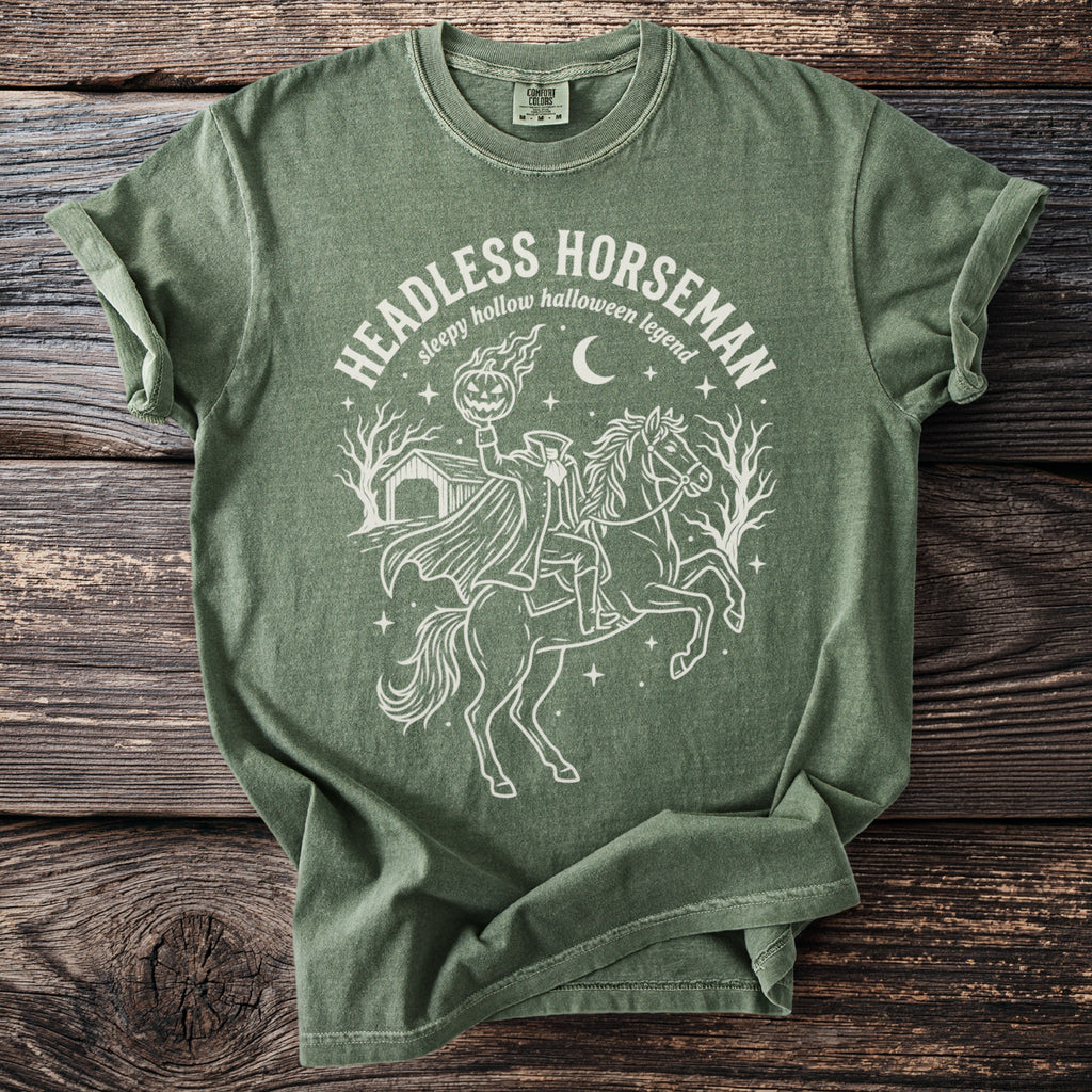 Green t-shirt with Headless Horseman and pumpkin graphic and text.