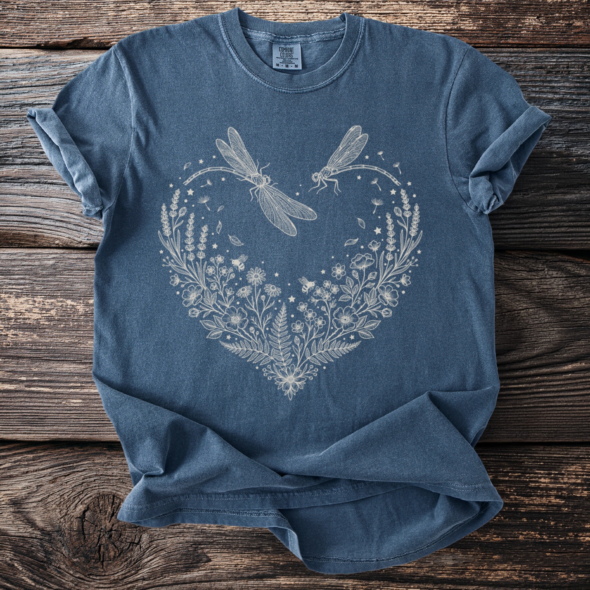 Blue t-shirt with cream outline heart of dragonflies, bees, and flowers.