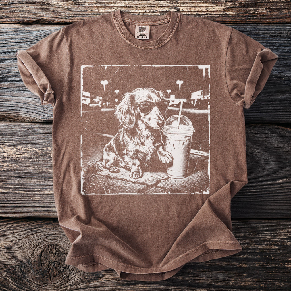 Brown t-shirt featuring a vintage graphic of a dachshund wearing sunglasses with a drink.