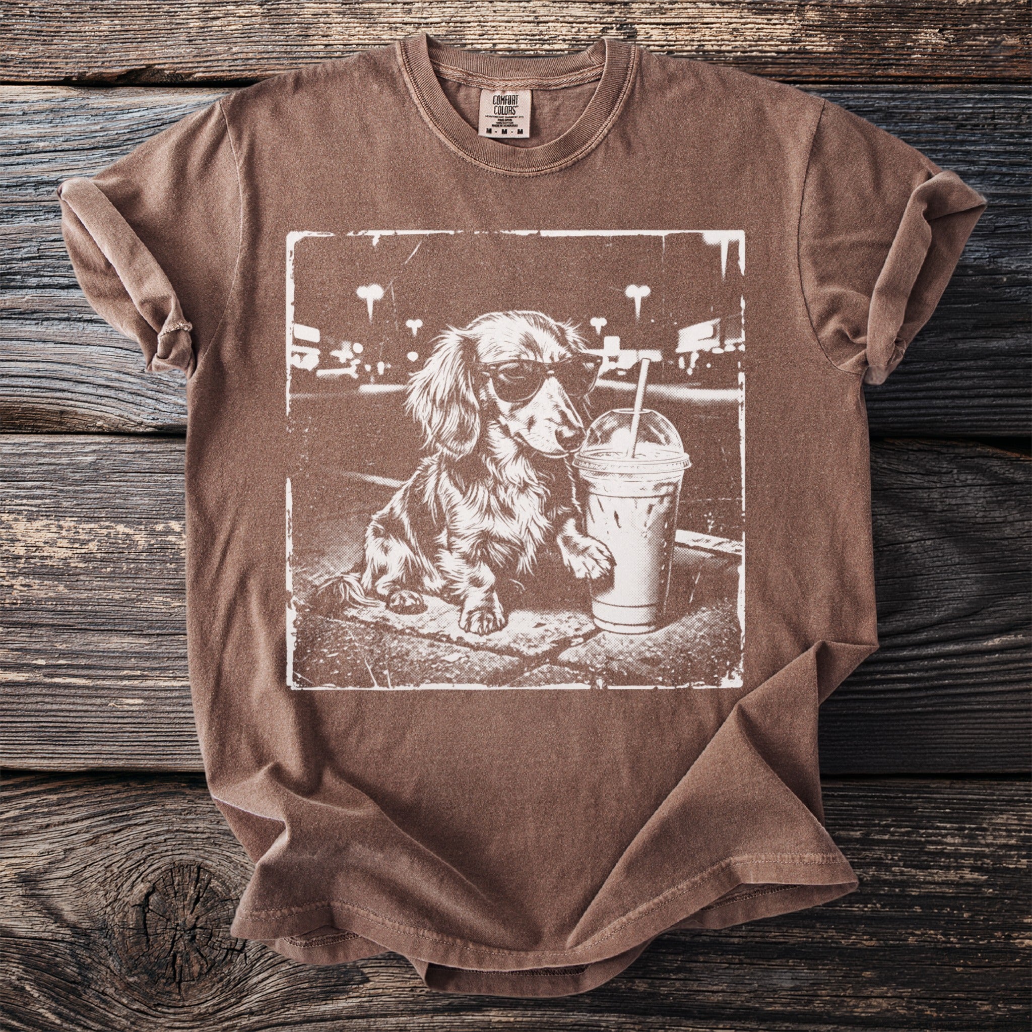 Brown t-shirt featuring a vintage graphic of a dachshund wearing sunglasses with a drink.