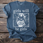 Blue t-shirt with white text "girls will be girls" and a spider graphic.