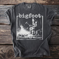 Bigfoot t-shirt graphic with text "bigfoot grabbed my weiner" and Bigfoot cooking by a fire.