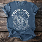 Blue t-shirt with white graphic of a swamp creature and text "JENNY GREENTEETH english river hag folklore".