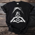 Black t-shirt with a hooded figure making a heart shape with coins.