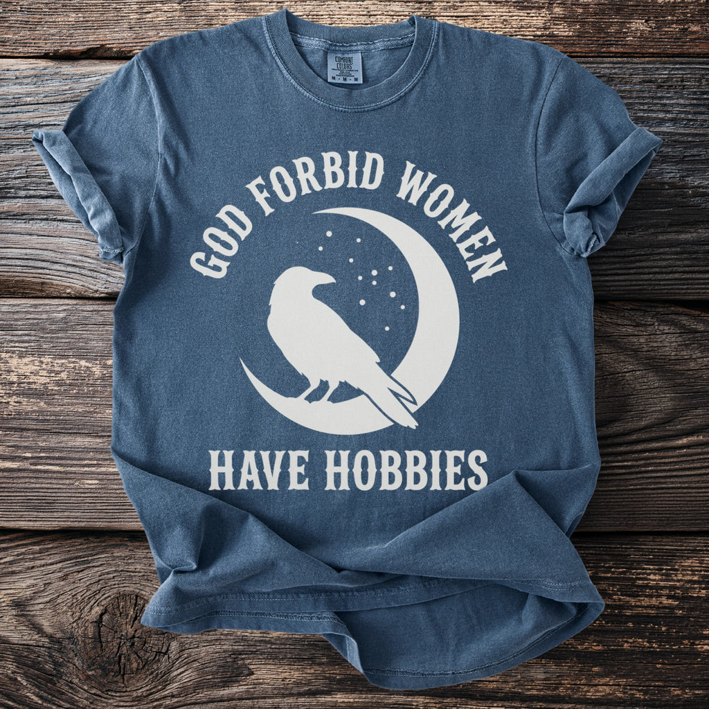 Blue t-shirt with white text and raven silhouette on a moon.