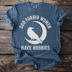 Blue t-shirt with white text and raven silhouette on a moon.