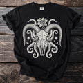 Black t-shirt with cream-colored graphic of ram skull, tentacles, flower, stars, and moons.