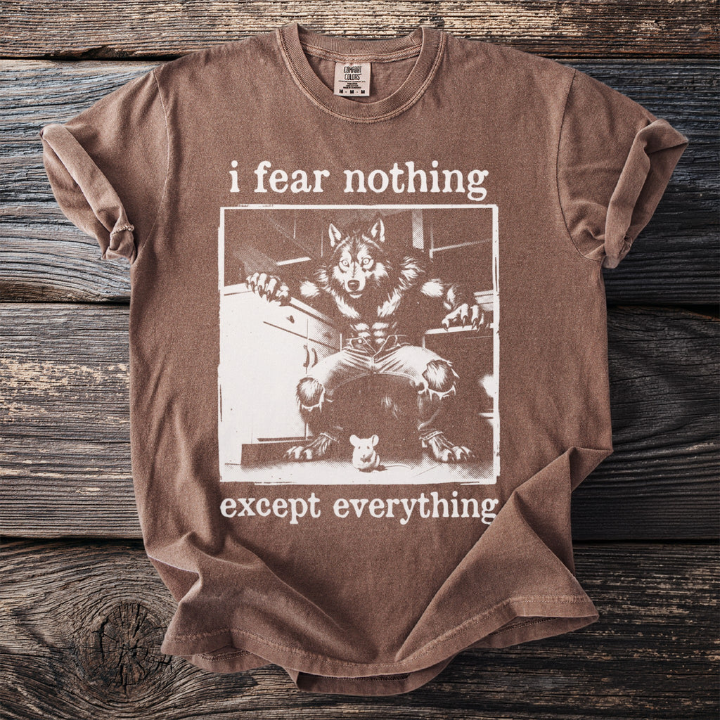 Brown t-shirt with werewolf graphic and text "i fear nothing except everything".
