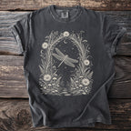 Dark grey t-shirt with creamy white linework art of a dragonfly in a floral archway.