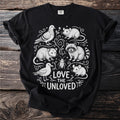 Black t-shirt with white line art of a raccoon, possum, mice, pigeon, seagull, and beetle with text "Love the Unloved".