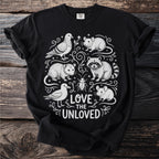 Black t-shirt with white line art of a raccoon, possum, mice, pigeon, seagull, and beetle with text "Love the Unloved".