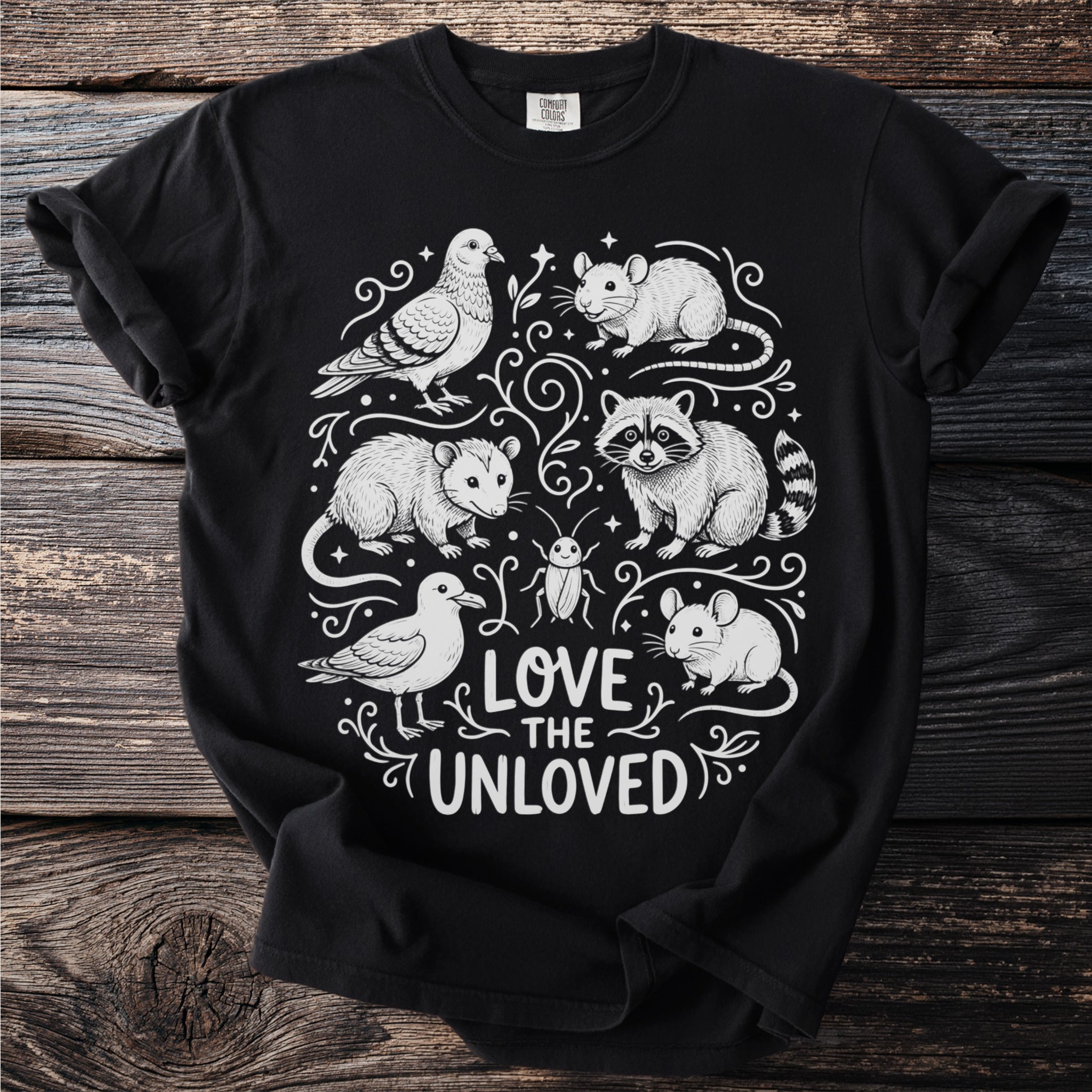 Black t-shirt with white line art of a raccoon, possum, mice, pigeon, seagull, and beetle with text "Love the Unloved".