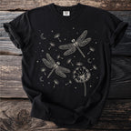 Black t-shirt with cream line art of two dragonflies, dandelions, moons, and stars.