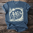 Blue t-shirt with a graphic of four skeletons running in a forest landscape.