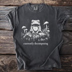 Dark gray t-shirt with a detailed graphic of a toad and mushrooms, text reads "currently decomposing".