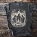 Dark t-shirt with occult scene: hooded figures, bonfire, moon, and nature elements.