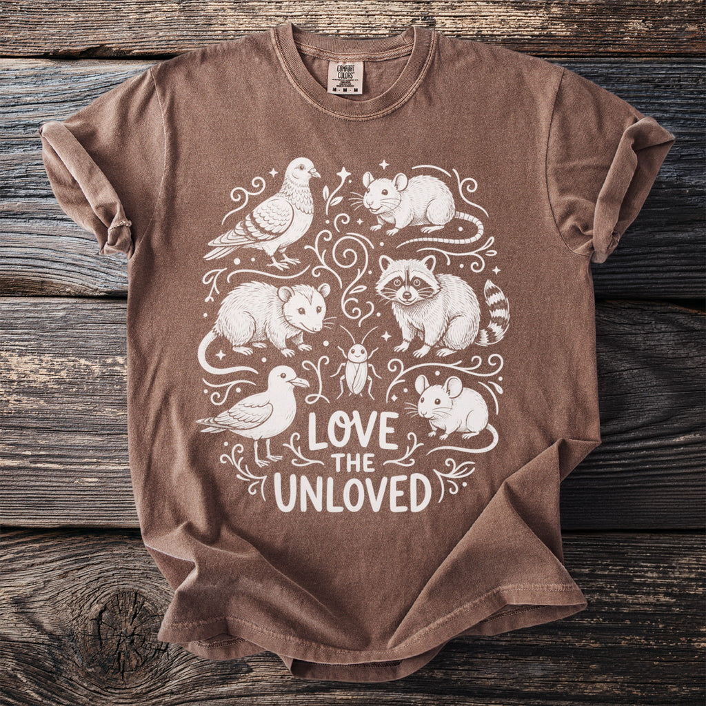 Brown t-shirt with white illustration of various animals and "Love the Unloved" text.